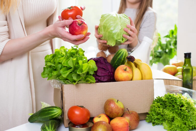 Food,Delivery.,Mom,And,Daughter,Unpack,A,Box,Of,Vegetables