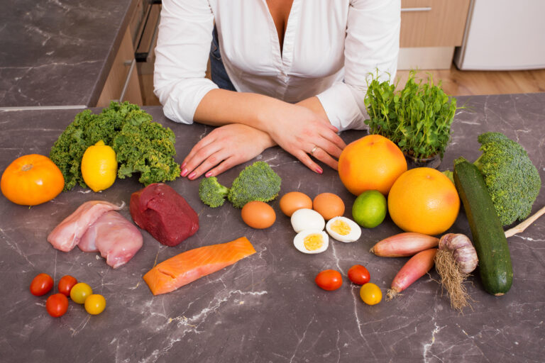 Woman,In,Kitchen,With,Different,Raw,Foods
