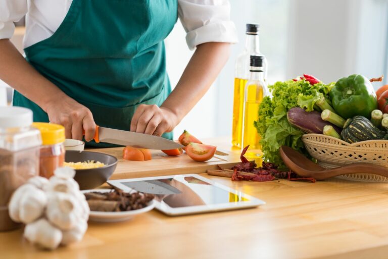 Woman,Following,Recipe,On,Digital,Tablet,And,Cooking,Healthy,Meal